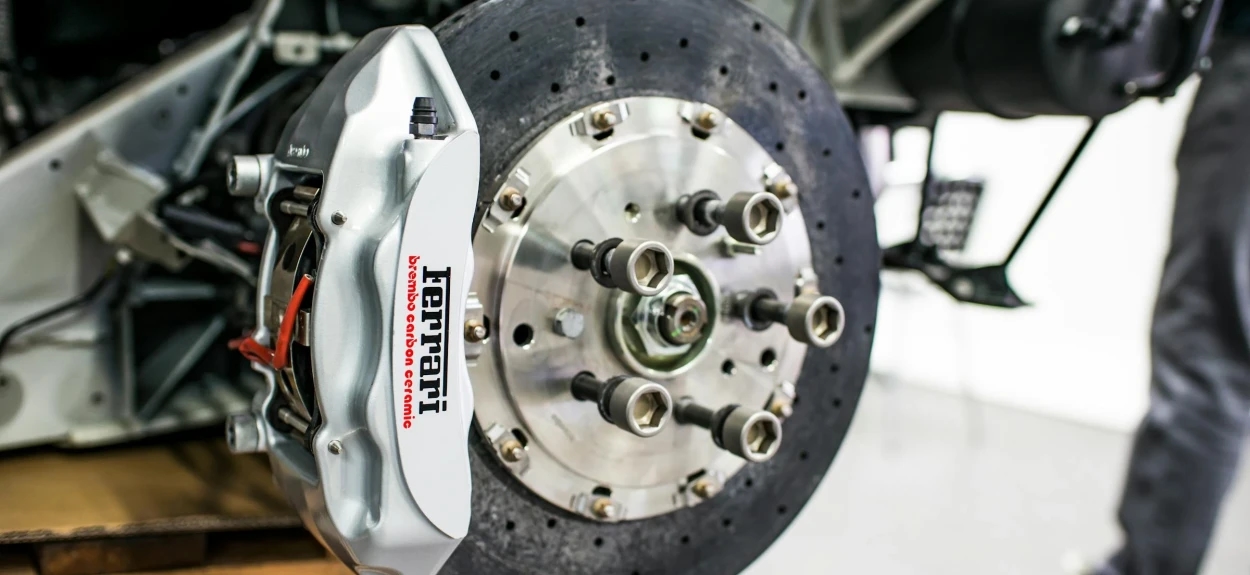 Detaljan prikaz ventiliranog kočionog diska i klešta na automobilu, primer sportskog kočionog sistema
